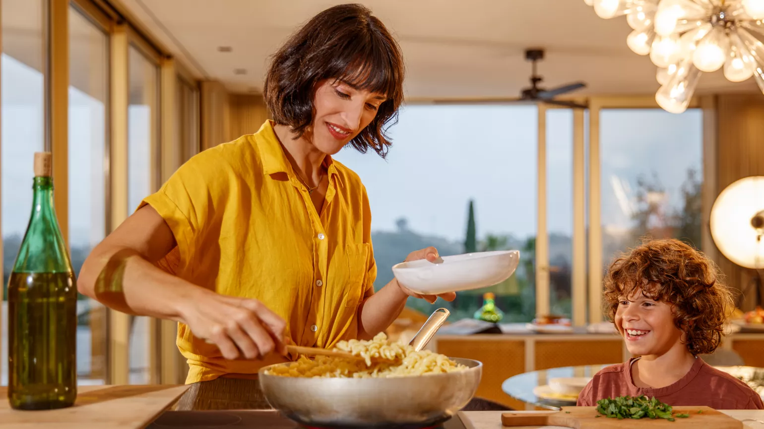 Mother and son cooking in kitchen