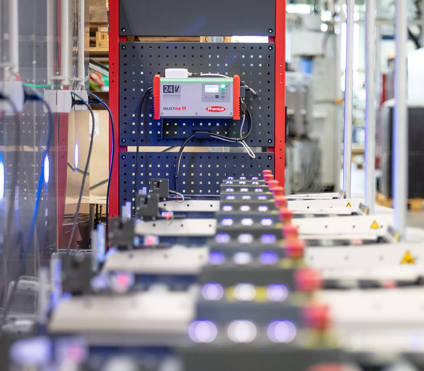Lithium-ion traction batteries in front of a SelectION battery charger.